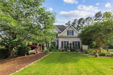 View of front of house featuring a front yard and brick siding