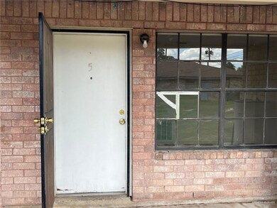 Property entrance featuring brick siding