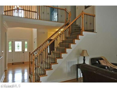 Entry. A large foyer introduces open main level with gleaming hardwoods