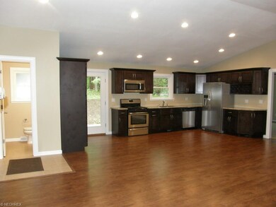 Open kitchen w/solid wood mocha cabinetry, granite