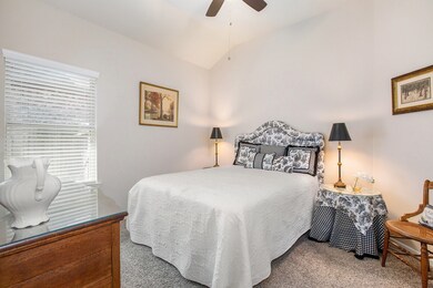 Near the front of the house is the first secondary bathroom.  It's complete with wooden window blinds and a ceiling fan.