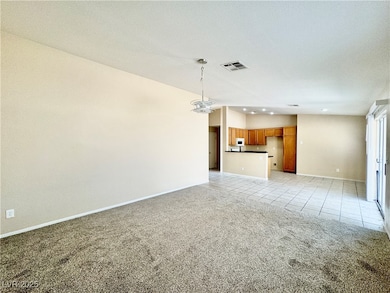 Living room to kitchen & front entry