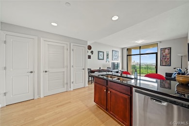 Kitchen featuring light wood-type flooring, sink,