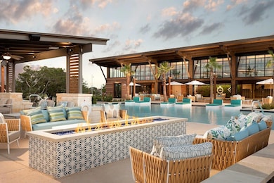 Pool at dusk with an outdoor living space with a 