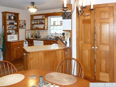 Large kitchen, eating area, wood stove & covered p