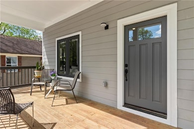 Entrance to property featuring covered porch