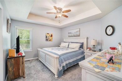 Primary bedroom with ceiling fan.