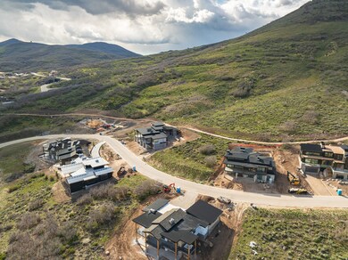 Aerial view of property and surrounding area with a mountainous background
