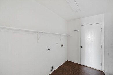 Clothes washing area featuring dark hardwood / woo