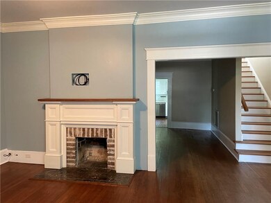 Living room showing fireplace with warm brick trim