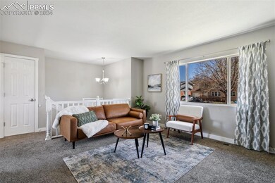 Living room with a notable chandelier and dark car