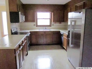 Large eat in kitchen with new stainless steel stove,microwave,dishwasher & refrigerator.