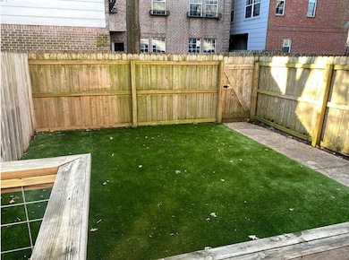 Gated yard with artificial turf for a year round beautiful green. Cozy and comfortable for dining out, entertaining, or just relaxing.