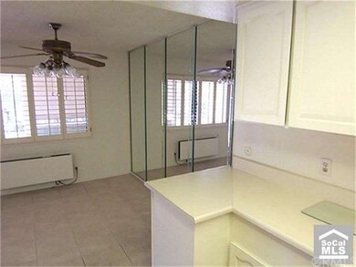 DINING AREA WITH CEILING LIGHT FAN & MIRRORED WALL