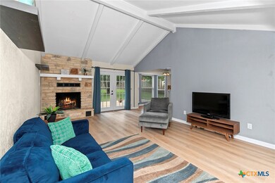 Spacious Living area with fireplace and french doo