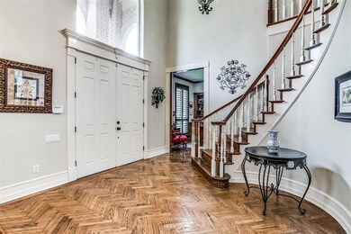 Stunning front foyer with herringbone wood floor accent