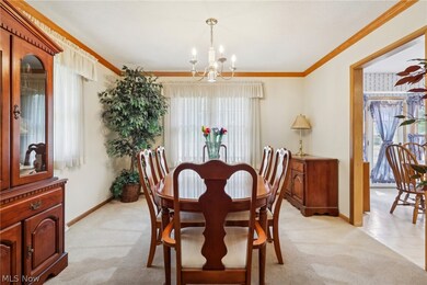 Formal dining room with crown molding and neutral decor.  Very spacious for those holiday gatherings.