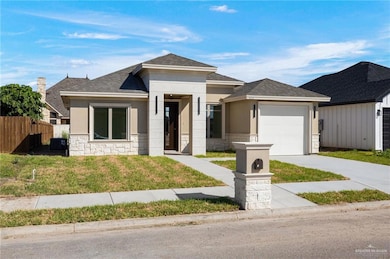 Prairie-style home with roof with shingles, stone siding, stucco siding, and driveway
