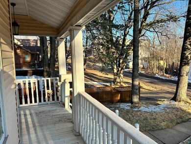Wooden terrace featuring covered porch