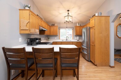 The eat-in kitchen overlooks the kitchen with newer appliances and light fixtures