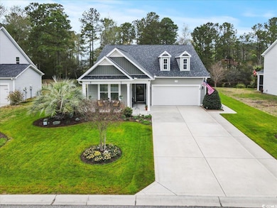 View of front of home with driveway, a shingled ro