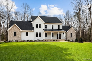 Modern farmhouse featuring a porch, board and batten siding, a front yard, a standing seam roof, and crawl space