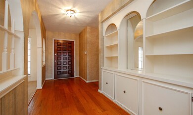 View toward front door, formals on left and built-
