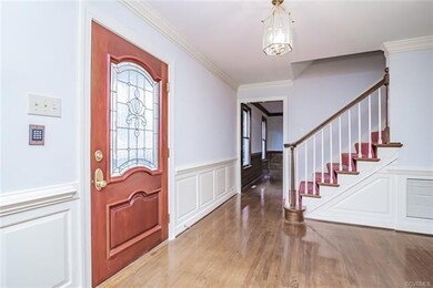 Leaded glass door leads to large foyer, front stai