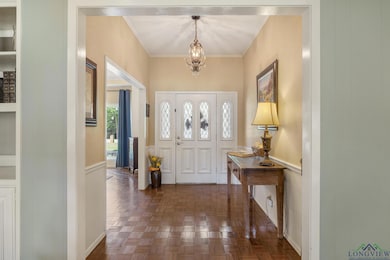 Foyer entrance with crown molding and a notable ch