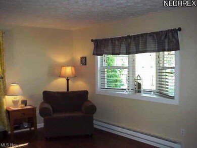 Living room is amply sized with pergo flooring and welcoming decor.