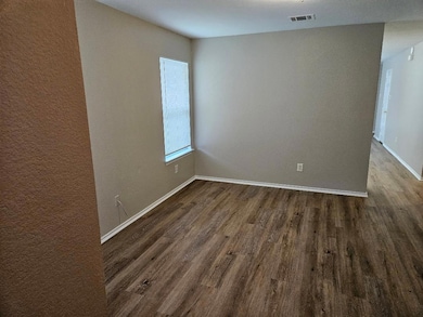 Spare room featuring dark wood-type flooring and 