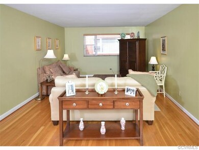 The living room has hardwood floors, two coat clos