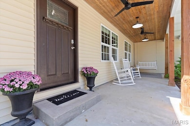 Imagine relaxing on this front porch swing, watching the storms roll in. Ceiling fans make the warmer weather more enjoyable and shiplap ceiling adds character!