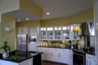 The kitchen is sleek and modern with ample storage