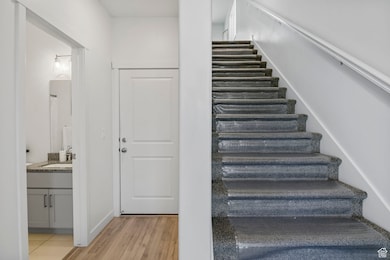 Staircase featuring wood finished floors