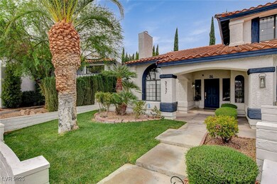 View of front of house featuring a tiled roof, stucco siding, a porch, and a chimney
