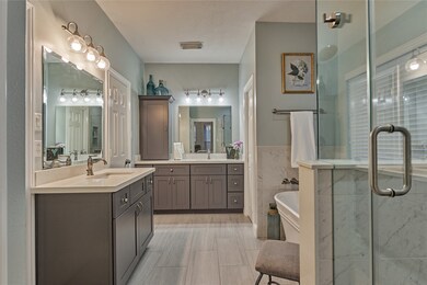 Updated primary bathroom with dual vanities and pl