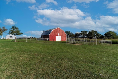 View of yard featuring an outbuilding and a rural 