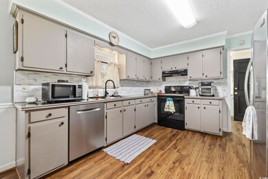 Kitchen featuring crown molding, backsplash, dark 