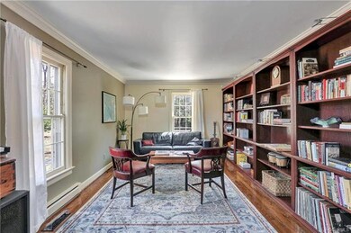 Formal living room with book cases, large windows,