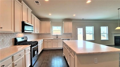 Kitchen featuring a sink, crown molding, visible v
