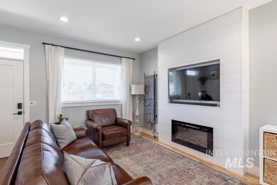 Living room with a fireplace, wood finished floors, and recessed lighting