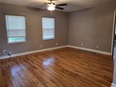 Unfurnished room with hardwood / wood-style flooring and ceiling fan