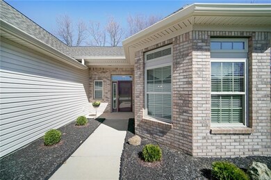 Landscaped entry with evergreen shrubs.