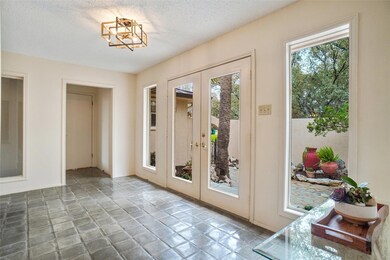 Doorway to outside featuring a textured ceiling, 