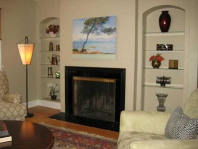 Living Room.  Charming twin arched built-ins flank