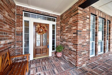 As you approach the front entry you will appreciate the full covered patio finished in brick pavers for a true custom feel. Guests will be protected from the elements when they come to visit.   Take a seat and enjoy a visit with your neighbors.