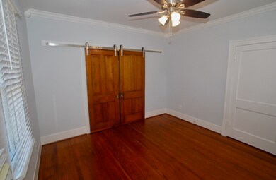 Spacious closet with built-ins is behind door on r