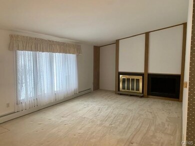 Living room with wood burning fireplace.