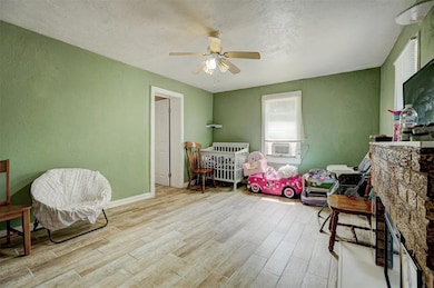 Bedroom featuring cooling unit, light hardwood / w